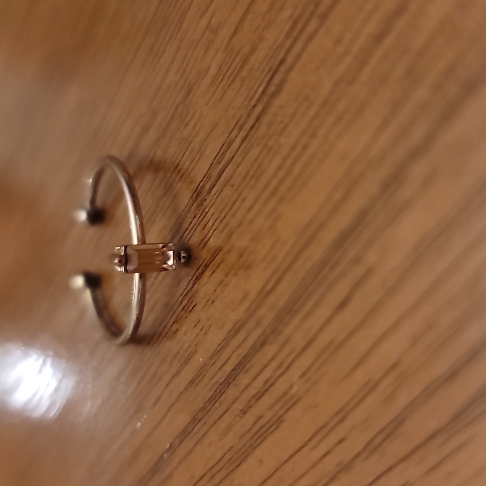 Gold plated ring with a pink center stone size 7